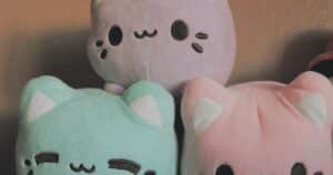 A row of stuffed animals sitting next to each other, representing a bulk custom plush production run priced by quantity.