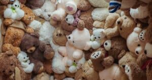 A wall covered in many teddy bears, illustrating the volume of plush units involved in a typical custom plush minimum order quantity.
